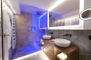 蓬高圣约翰唐纳霍夫阿尔卑斯生活方式酒店的一间带两个盥洗盆和淋浴的浴室