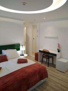 大洛希尼Hotel Villa Elisabeth - Veli Lošinj Health Resort的一间卧室配有一张大床和一张书桌