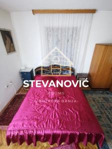 VrnjciStevanovic Smestaj的一间卧室配有一张红色的床和窗户