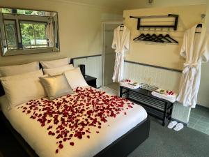 The PatchThe Mountain View Cottage的一间卧室,床上有红色的鲜花