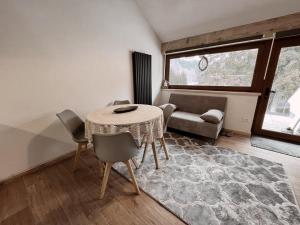 拉瓦罗内Loft Malga Laghetto的客厅配有桌椅和沙发