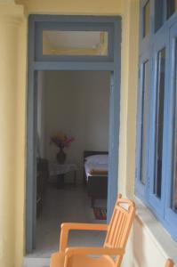 奈尼塔尔Lakshmi Kutteer Homestay的客房设有窗户和阳台椅子