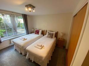 爱丁堡Hopetoun Apartment with free parking的一间卧室设有两张床和窗户。