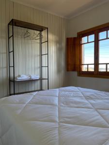 本图贡萨尔维斯Casa Vita BG - Casa de campo的卧室内的一张大白色床,带有窗户