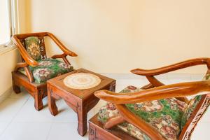 玛琅OYO Life 91569 Omah Wijaya Kusuma Syariah的客厅配有两把椅子和一张桌子