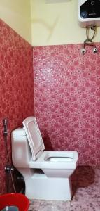 甘托克Hotel Nindik的一间带卫生间和红色墙壁的浴室