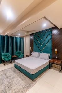 拉瓦尔品第Penthouse by Shelton的一间卧室配有大床和绿色窗帘
