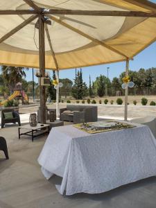 莱切省卡瓦利诺B&B Ulivi d'argento的一个带桌子的大帐篷,位于庭院