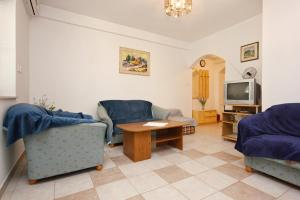 洛维什特Apartments by the sea Loviste, Peljesac - 10182的客厅配有两把椅子、一张桌子和一台电视