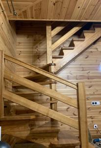 波恰耶夫Rodynne Gnizdo的小木屋内的楼梯,铺有木地板