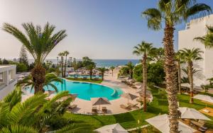 哈马马特Royal Azur Thalassa的享有棕榈树度假村游泳池的顶部景致
