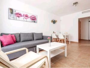 拉阿尔加瓦Apartamento con patio y piscina cerca de Sevilla的客厅配有沙发和桌子