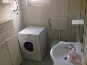 乌格连Apartments by the sea Muline, Ugljan - 12533的小型浴室设有洗衣机和水槽。