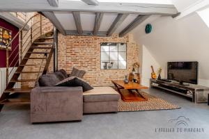 索恩河畔沙隆Superbe Loft, Chalon sur Saône的带沙发和砖墙的客厅