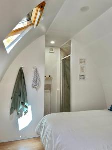 威尔汉姆Nuthatch Cabin at Cloudshill Glade的卧室配有白色的床和窗户。