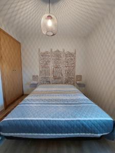 萨布盖鲁Casa do Pátio的一间卧室配有一张大床和木制床头板