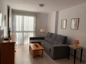 安波拉Precioso apartamento cerca de la playa的客厅配有沙发和桌子
