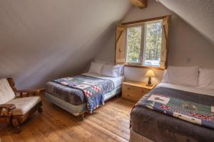 费尔蒙特温泉蒂姆伯斯度假村宾馆的一间卧室设有两张床、一把椅子和一个窗户。