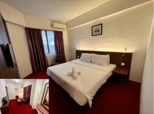瓜拉丁加奴瓜拉丁加奴中城酒店的酒店客房的床铺上配有2条白色毛巾