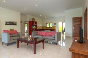 乌明亚北角海滩别墅的客厅配有两张沙发和一张咖啡桌