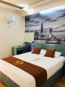 海防科济酒店的一间卧室,配有一张带城市绘画的床