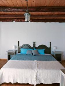 法马拉Casa Salitre的一间卧室配有一张带蓝色枕头的大床