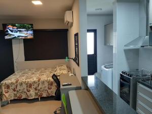 里贝朗普雷托Nova Aliança 66-wifi-estacionamento-pet friendly的一间小卧室,配有一张床和一台墙上的电视