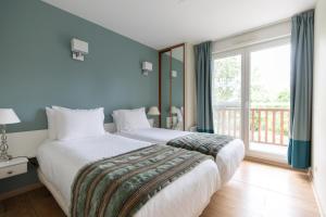 科内勒Club Wyndham Normandy的一间卧室设有一张大床和一个大窗户