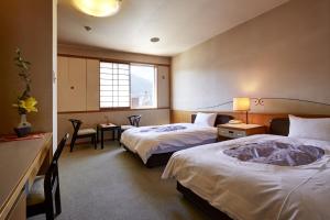新鹤田酒店客房内的一张或多张床位