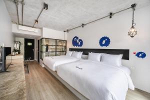 蔻立Kokotel Khao Lak Lighthouse - SHA Extra Plus的卧室配有两张大型白色床