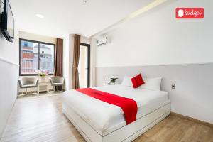 头顿Khanh Linh Hotel的卧室配有红色色调的白色床