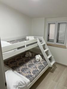 斯卡莱阿Residence Borghi的卧室配有两张双层床,地板上放有动物。