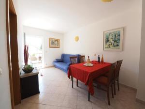 斯拉诺Apartments and rooms by the sea Slano, Dubrovnik - 2682的一间带桌子和蓝色沙发的用餐室