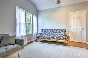 Peaceful Kansas Cottage with Wraparound Deck!的带沙发和窗户的客厅
