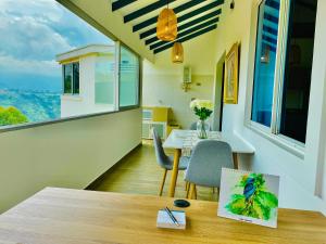 佛罗里达布兰卡Ruitoque Apartamento Campestre Maravillosa Vista的客房设有桌椅和窗户。