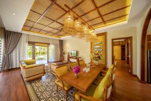 绥和市Sao Mai Beach Resort的客厅配有木桌和黄色椅子