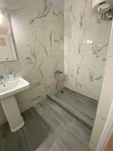 阿纳维索斯Christy's House Anavissos / Ανάβυσσος的白色的浴室设有水槽和淋浴。