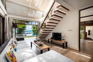 湄南海滩The Emerald Hill Beach Villa的带沙发和楼梯的客厅