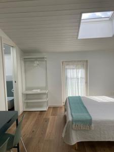 加尔多内-里维耶拉BiancoGelso b&b Vegan的白色的卧室设有床和窗户