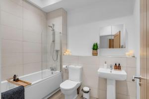 诺里奇Norwich Castle View Apt - Modern 2 Br的白色的浴室设有浴缸、卫生间和水槽。