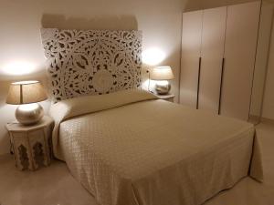 里杜德里伊斯坦西Hotel Azzurra的一间卧室配有一张大床和两盏灯。
