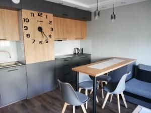 比亚韦斯托克Apartament Shadow的厨房配有桌子、椅子和柜台