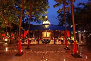 玛琅Hotel Tugu Malang - CHSE Certified的一座楼前棕榈树的婚礼场地