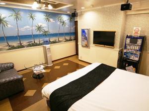 Yoshiokaメルヘンの森パート2大人専用的一间卧室配有一张床和一台电视,并种植了棕榈树