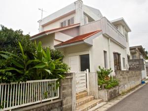 石垣岛Ishigaki - House / Vacation STAY 11269的前面有栅栏的白色房子
