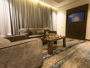 吉达White Diamond Hotel Sari的带沙发和电视的客厅