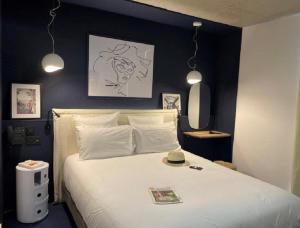 马蒂格Golden Tulip Martigues Provence的卧室配有一张白色大床和黑色墙壁