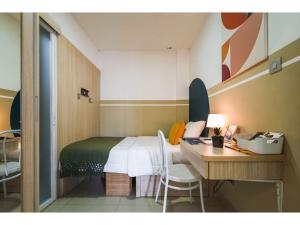 雅加达Cove T63的一间卧室配有一张床和一张书桌