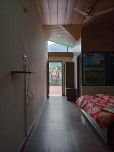 库尔卢SPOT ON Hotel Rudra的一间卧室设有一张床和一个大窗户