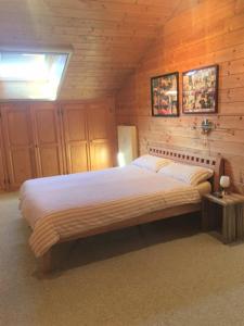 基姆湖畔普林Ferienwohnung Kunze的木制客房内的一间卧室配有一张大床